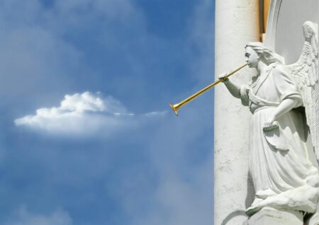 horning angel statuette