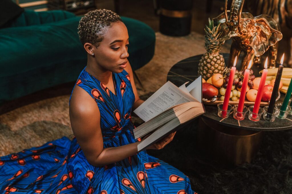 woman in blue kaftan dress reading book