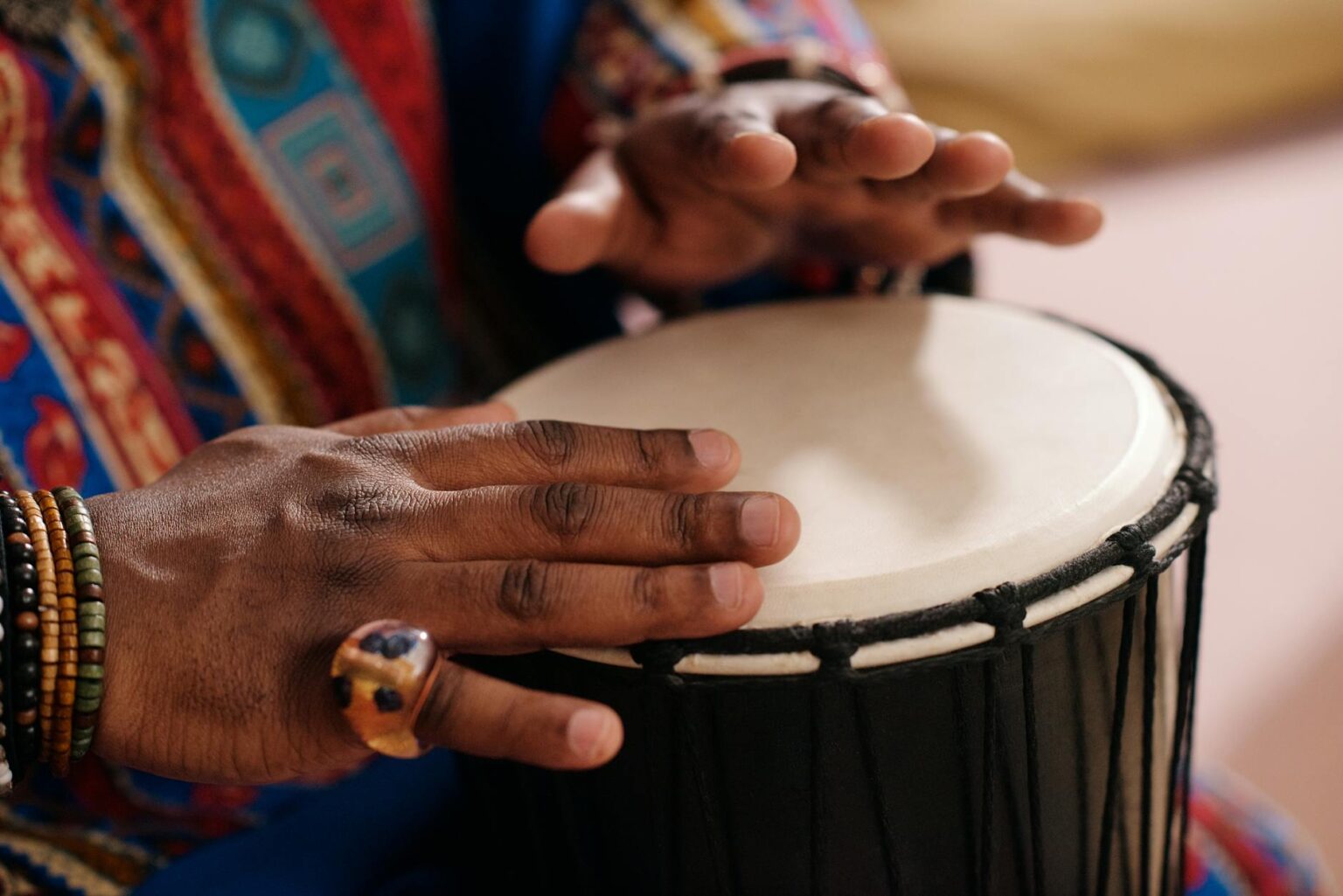close up photo of person playing djembe