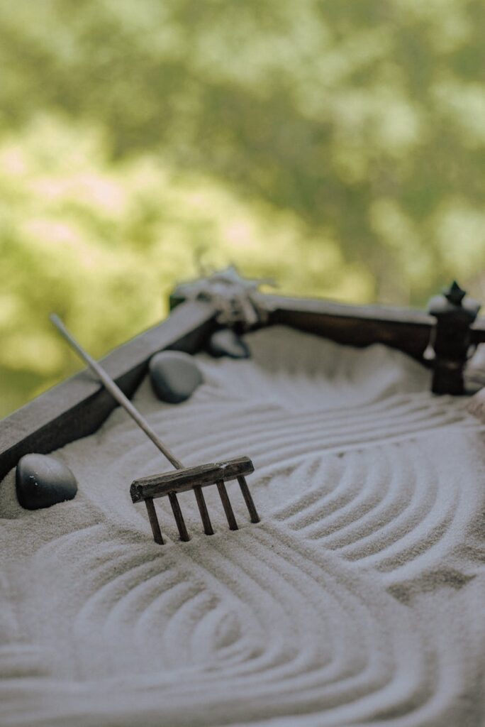 a miniature rake in a sandbox