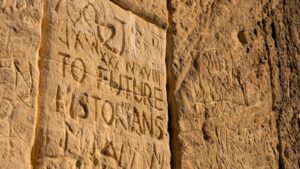 a close up of a stone wall with writing on it