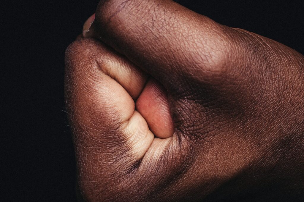 persons hand on black textile