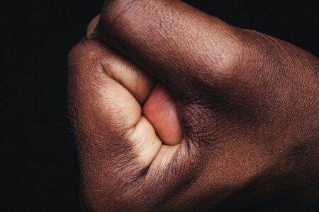 persons hand on black textile