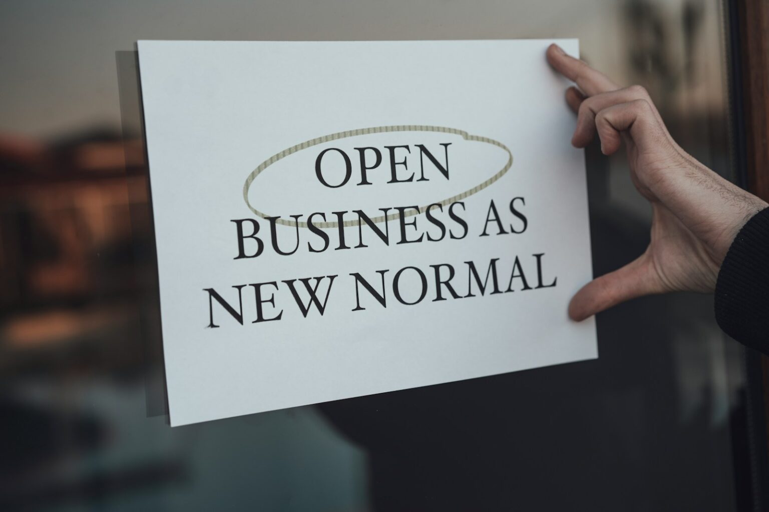 How to Properly Start a Business in The Maryland Republic Correctly a person holding a sign that says open business as new normal