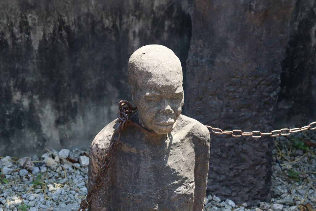 A statue of a person chained to a chain