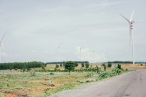 several wind turbines on the side of a road