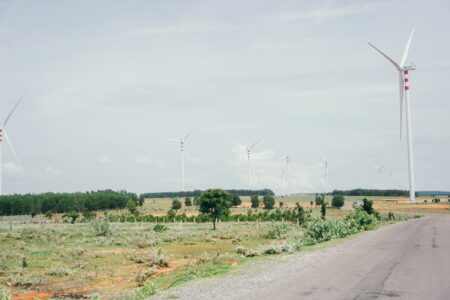 several wind turbines on the side of a road